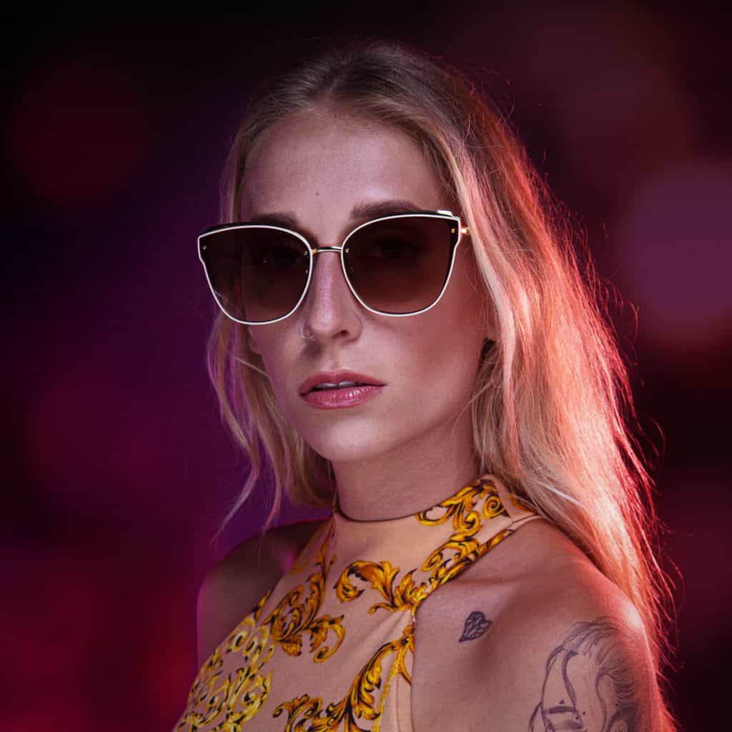 A beautiful blonde lady wearing FUBU Sunglasses